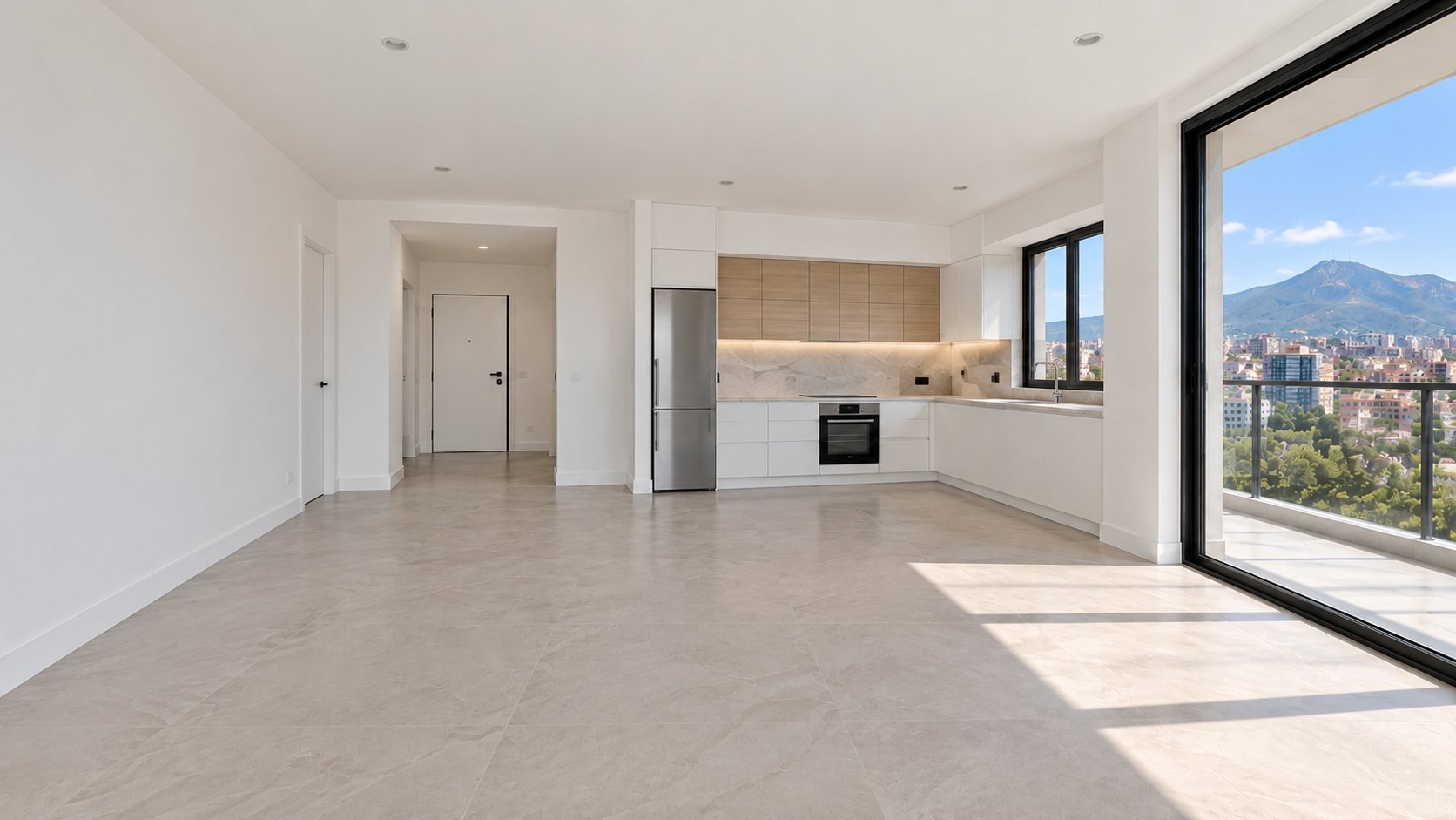Empty living room facing the corner kitchen and hall